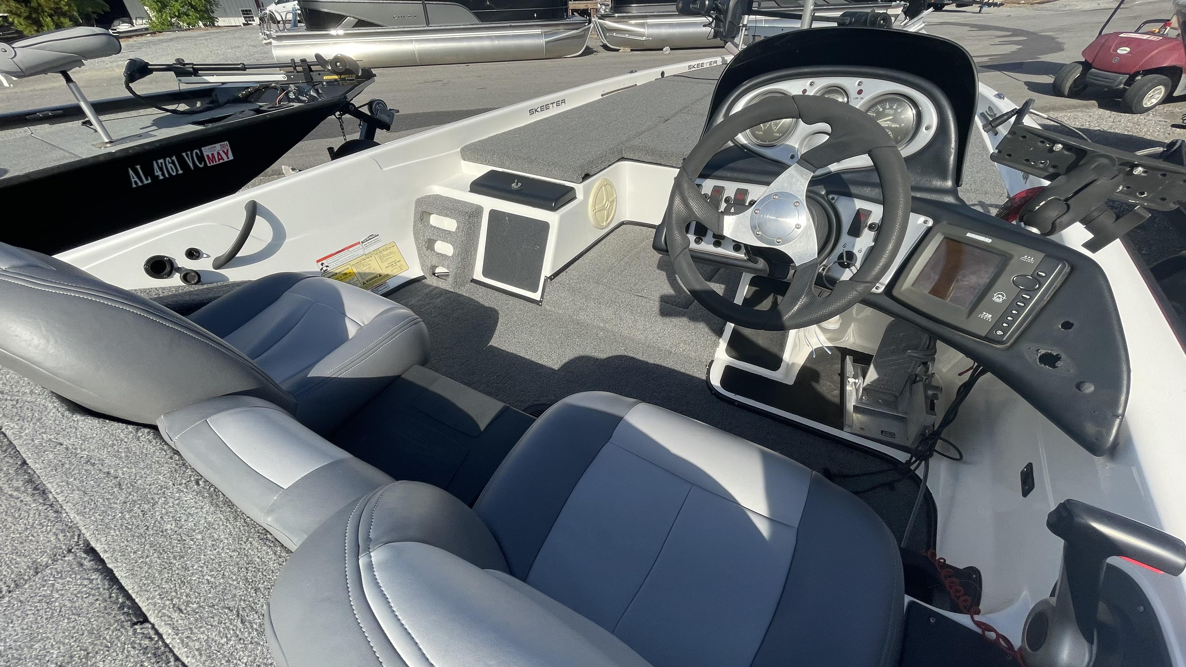 Slide: The Image of 2011 Skeeter ZX225 boat interior with steering wheel, seats, and control panel. - 21