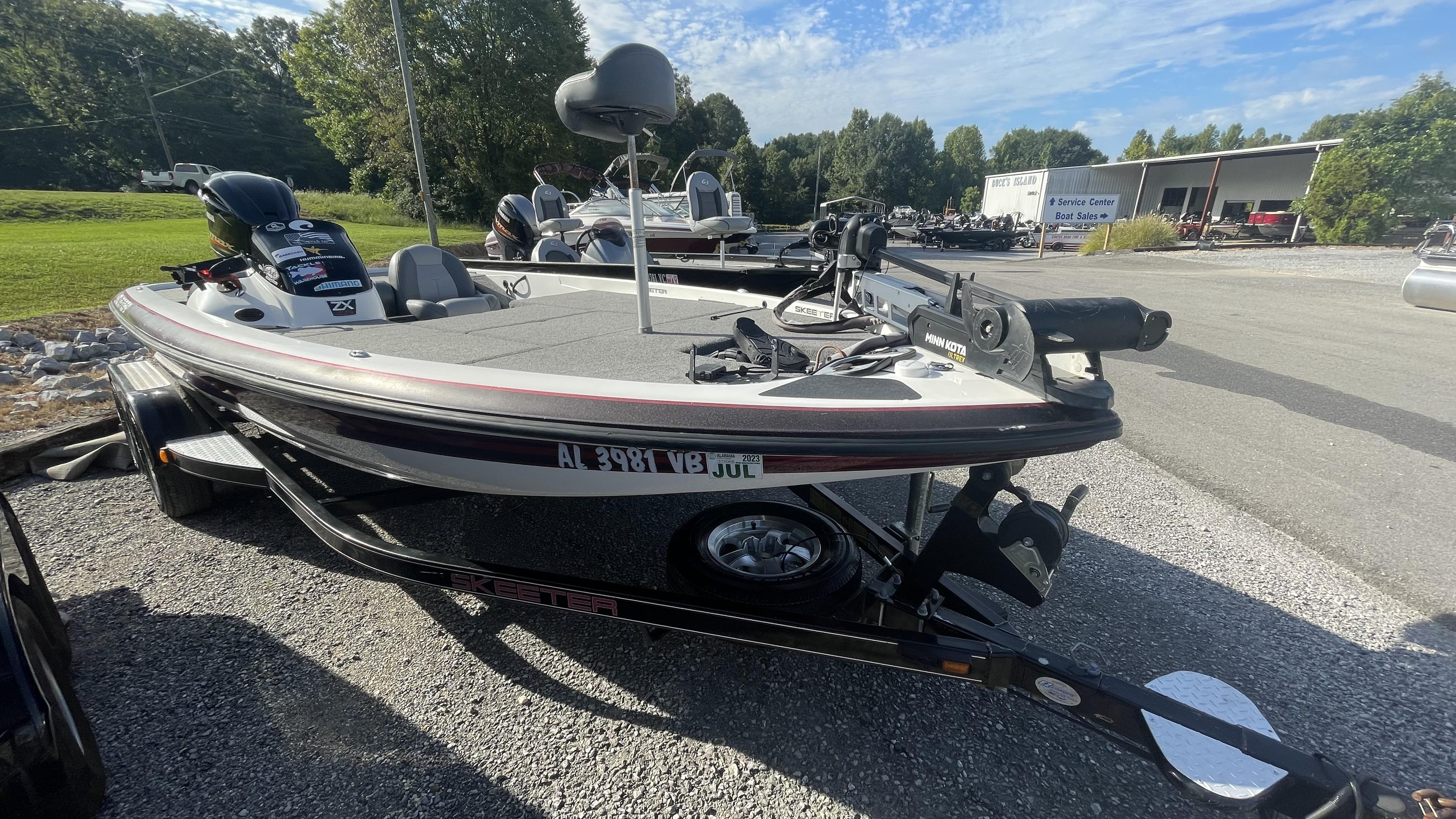 Slide: The Image of 2011 Skeeter ZX225 bass boat on trailer at dealership. - 3