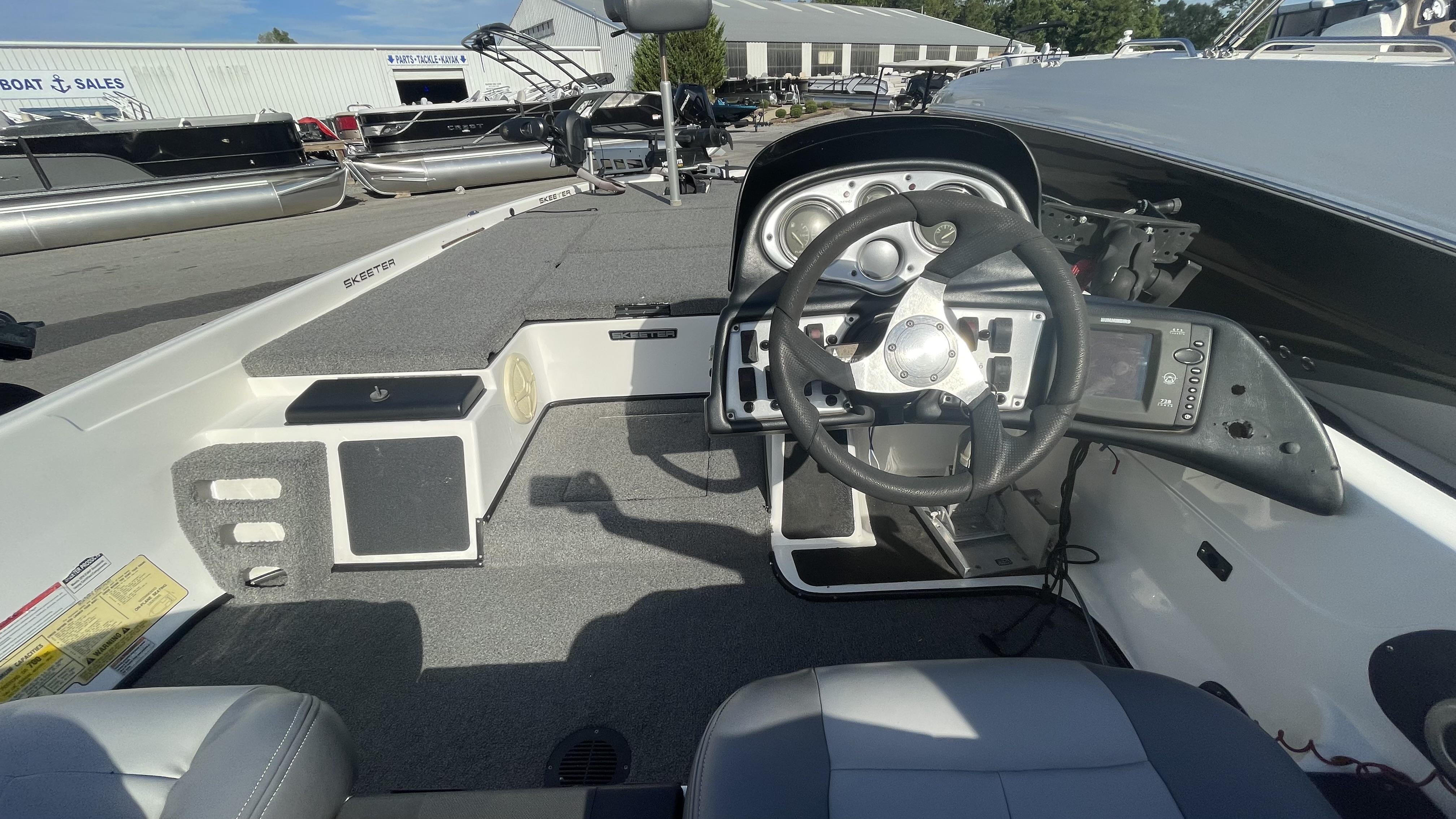 Slide: The Image of 2011 Skeeter ZX225 boat dashboard and steering wheel at a boat sales lot. - 8