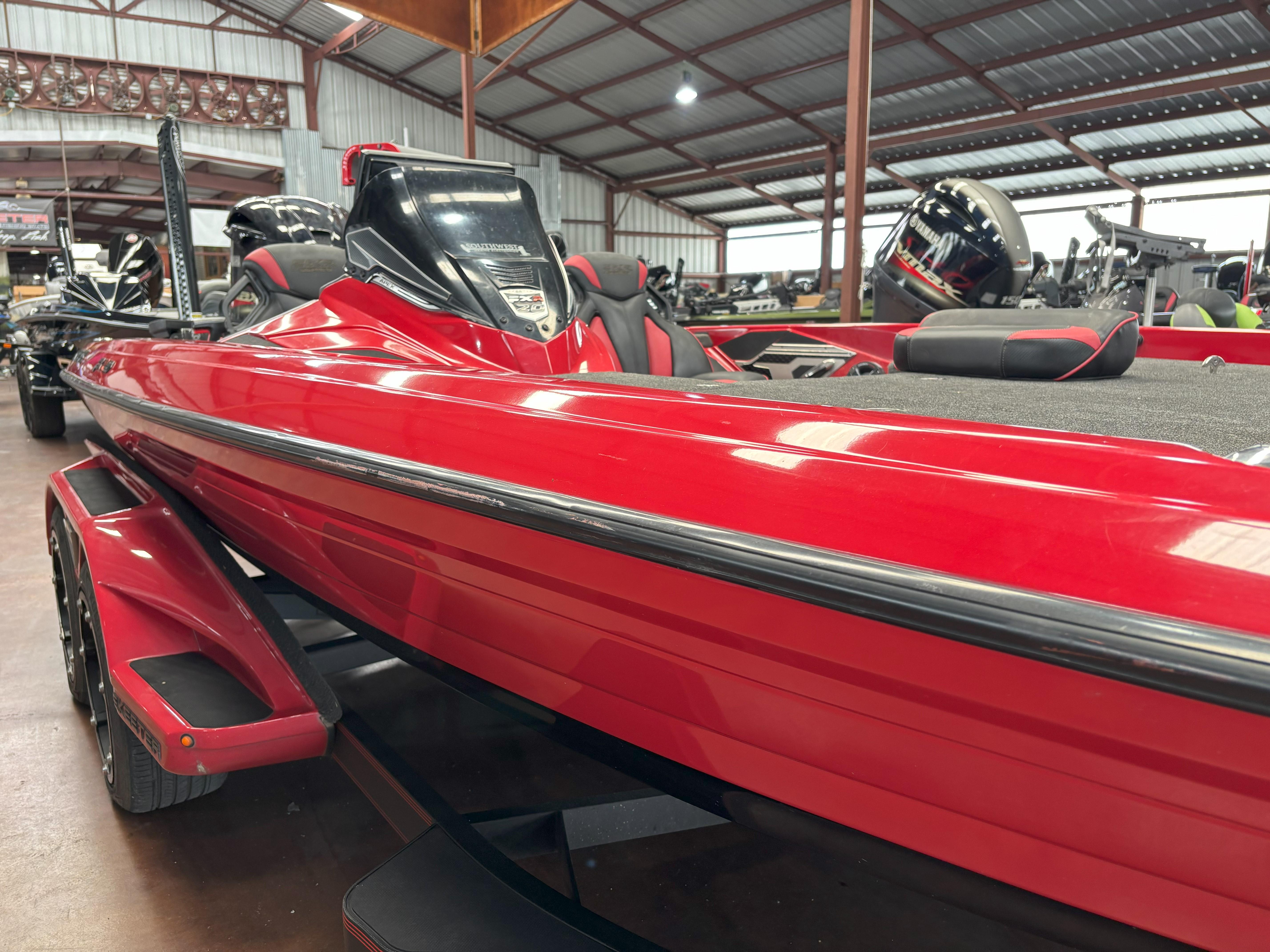 Slide: The Image of Red 2020 Skeeter FXR20 Apex boat in a showroom, showcasing sleek design and modern features. - 11