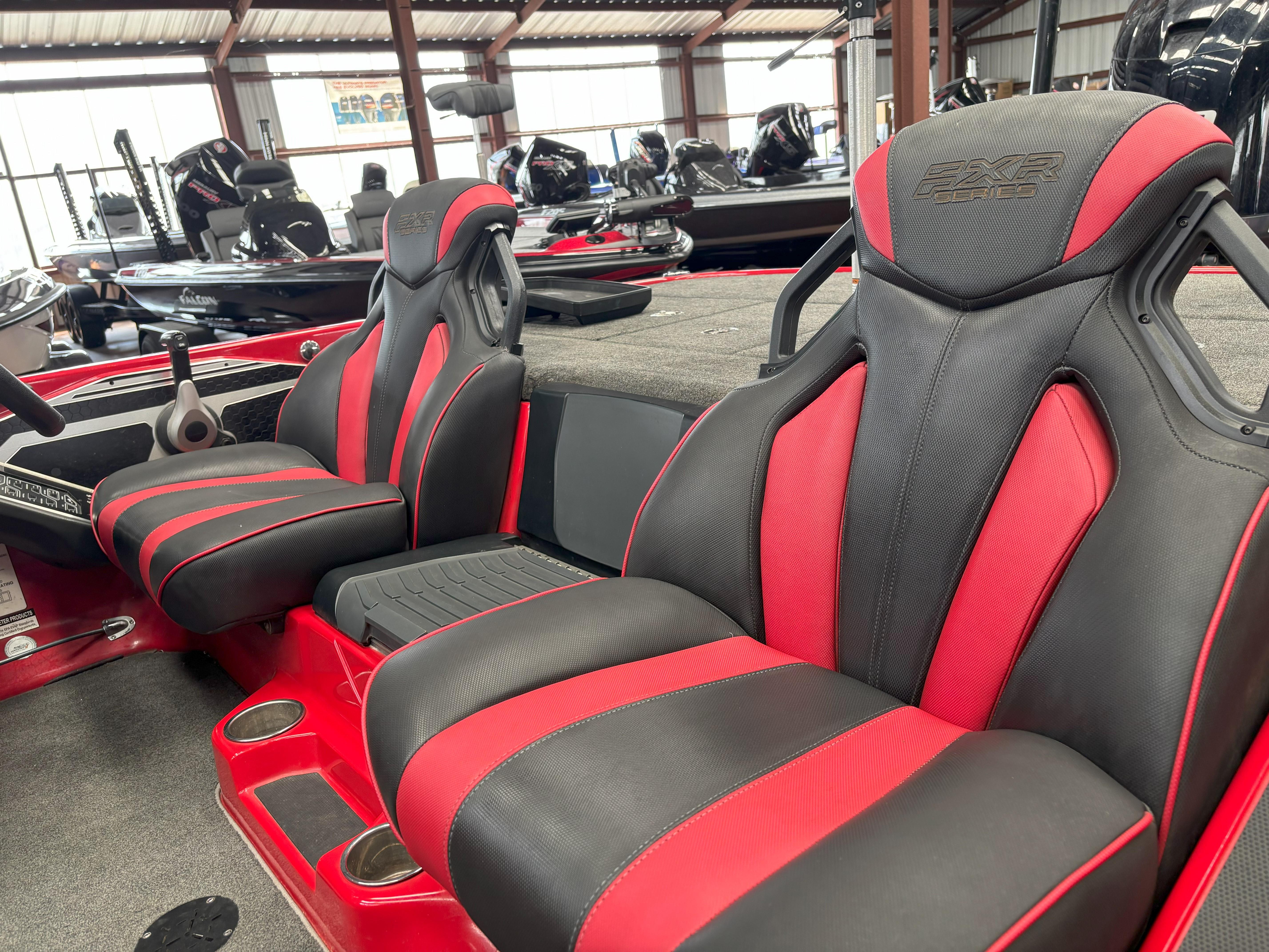 Slide: The Image of 2020 Skeeter FXR20 Apex boat interior with red and black seats in showroom. - 15