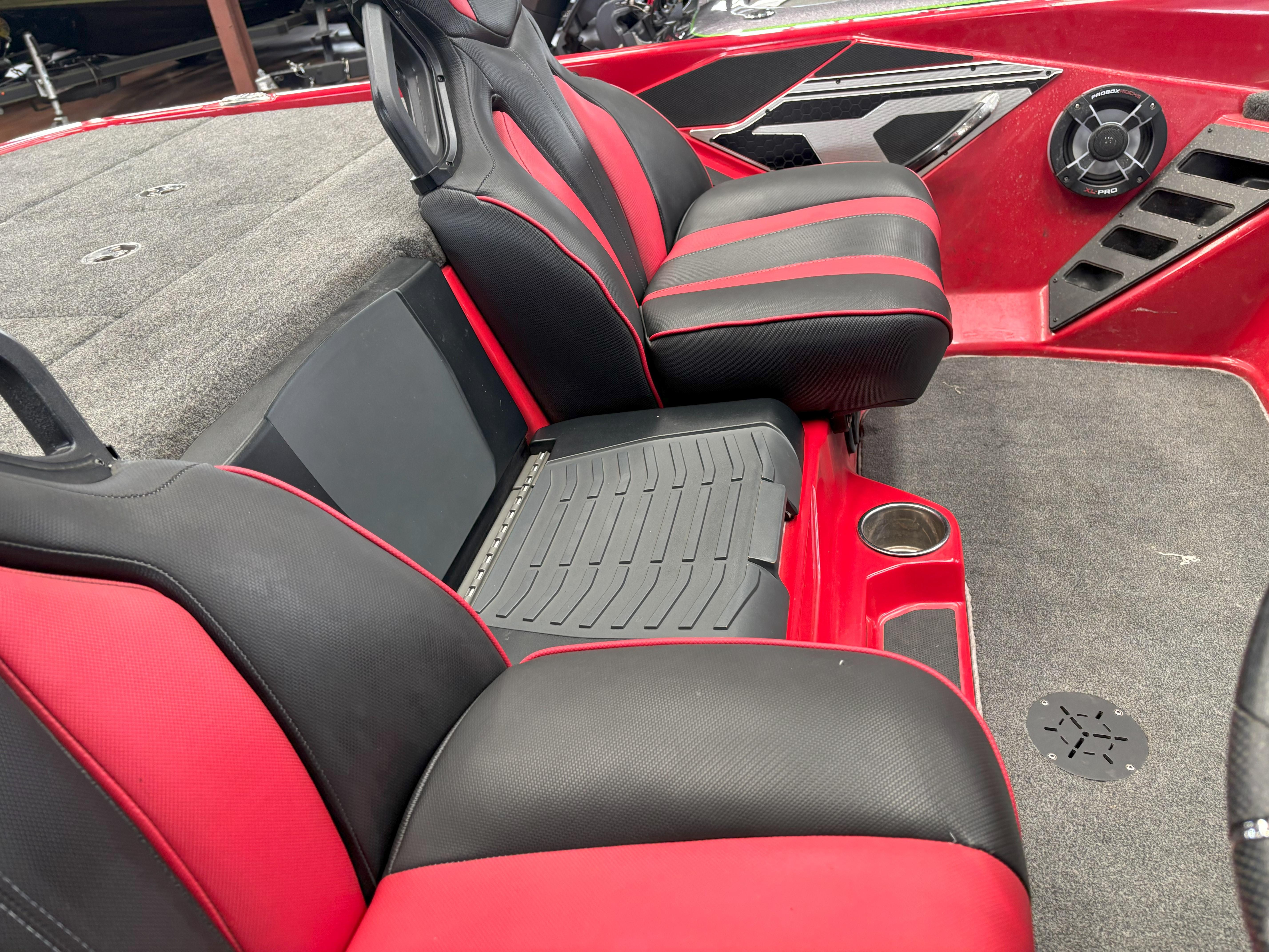 Slide: The Image of 2020 Skeeter FXR20 Apex boat interior with red and black seats, speaker, and carpeted flooring. - 17