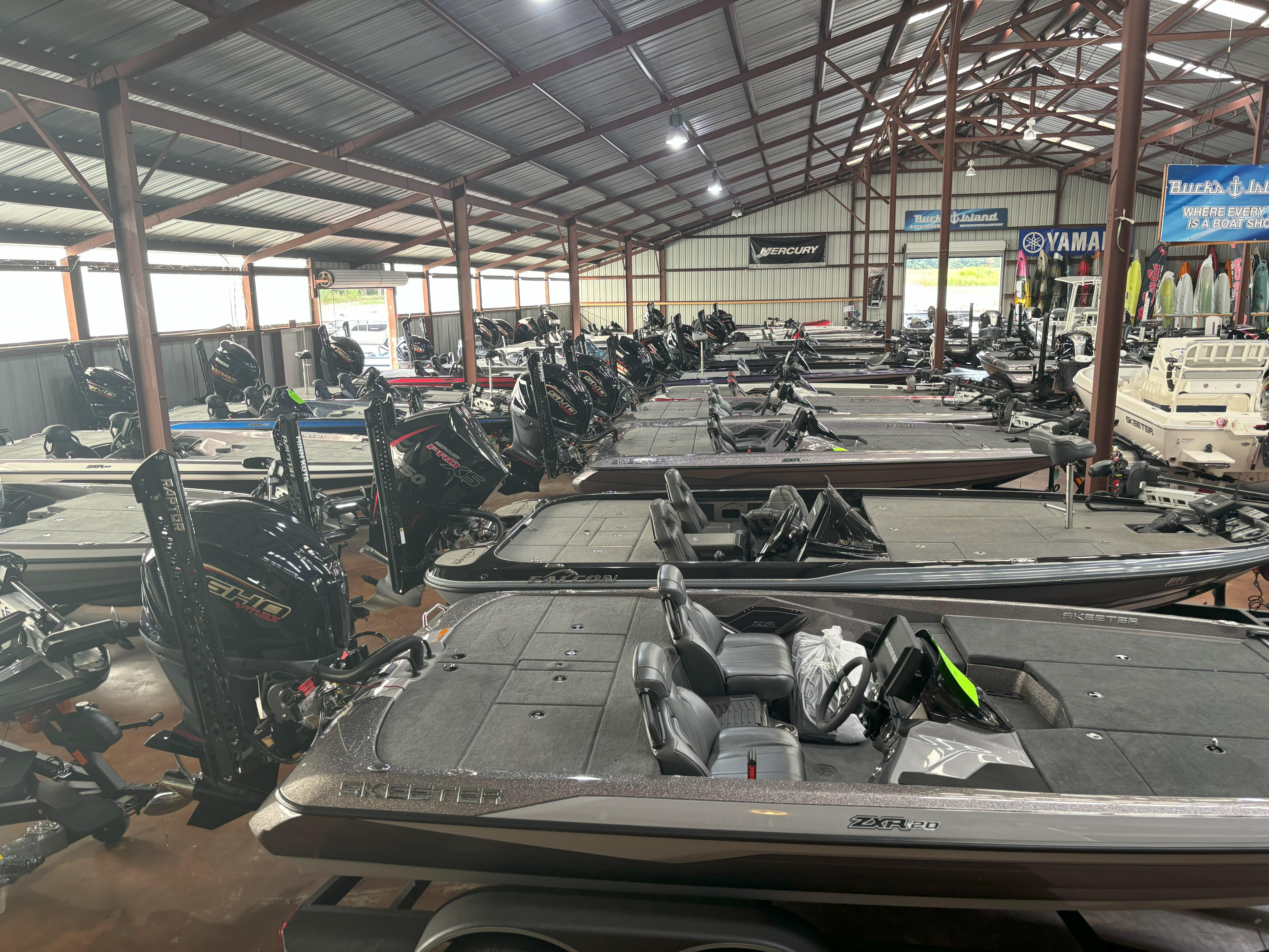 Slide: The Image of 2020 Skeeter FXR20 Apex boats displayed in a showroom with multiple models. - 2