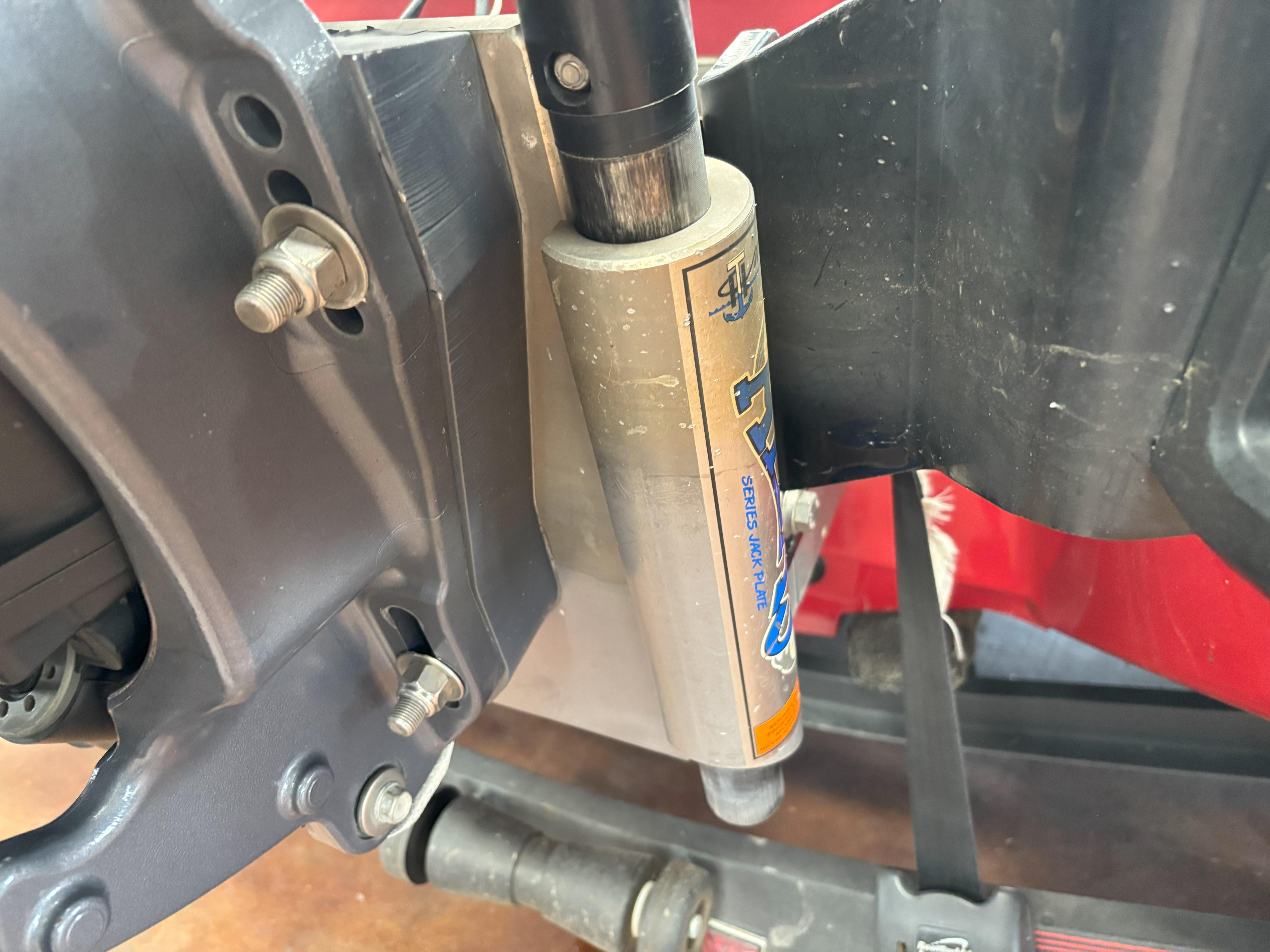 Slide: The Image of Close-up of a 2020 Skeeter FXR20 Apex boat component, featuring a hydraulic jack plate. - 23
