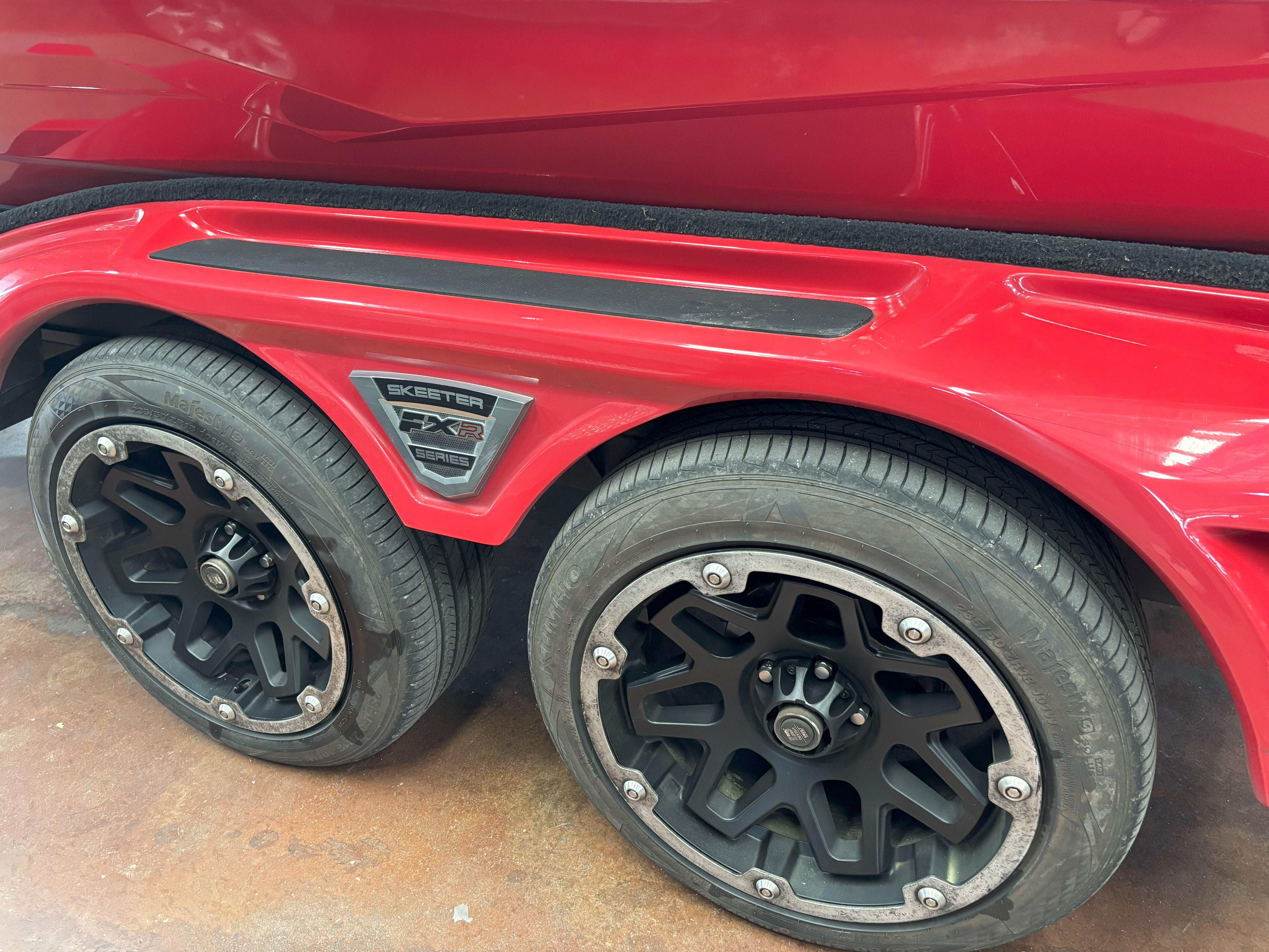 Slide: The Image of Red 2020 Skeeter FXR20 Apex trailer with black wheels and FXR Series badge. - 24