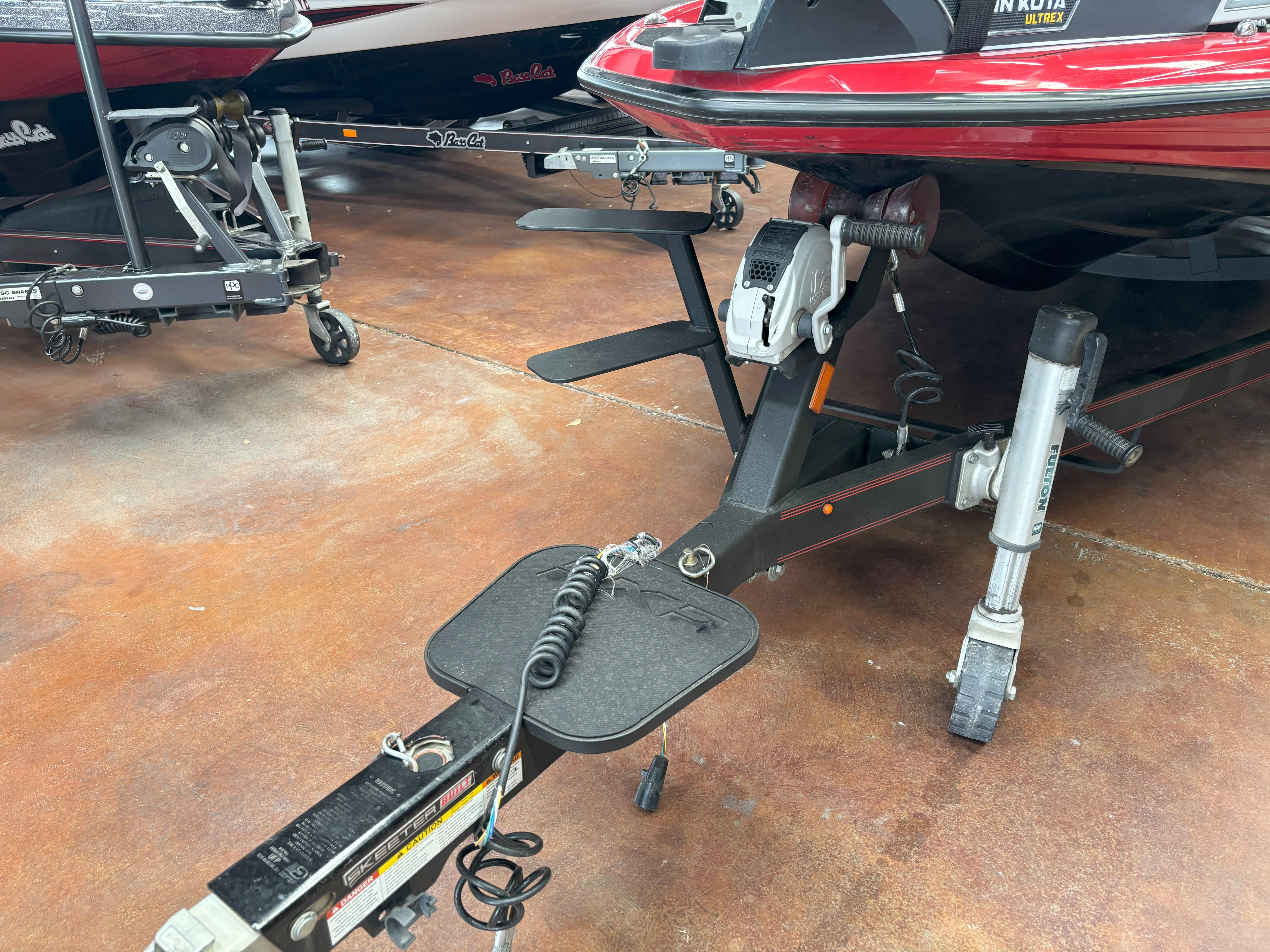 Slide: The Image of 2020 Skeeter FXR20 Apex boat trailer with Minn Kota Ultrex motor, displayed indoors. - 25