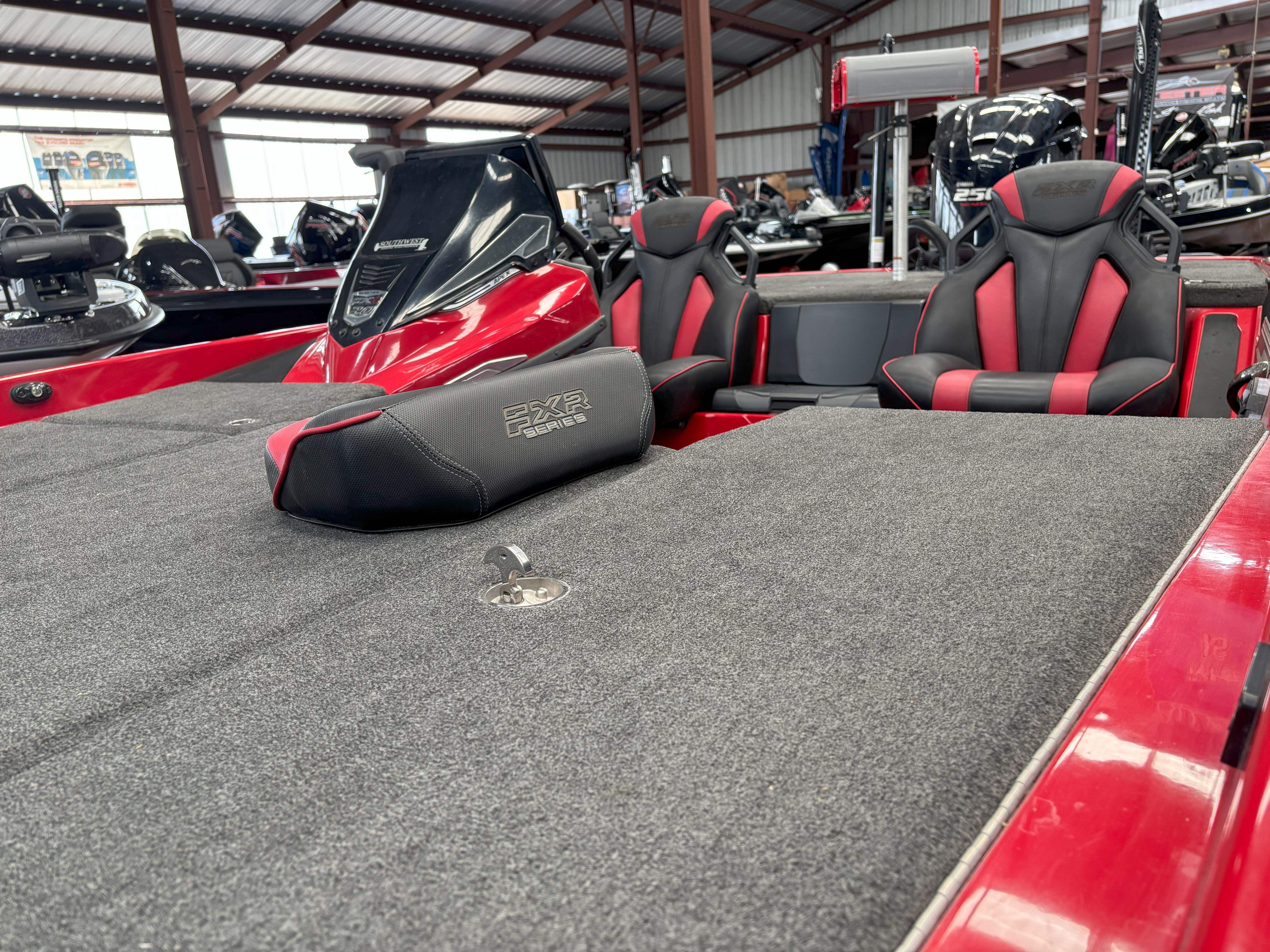 Slide: The Image of 2020 Skeeter FXR20 Apex boat interior with red and black seating in a showroom. - 7