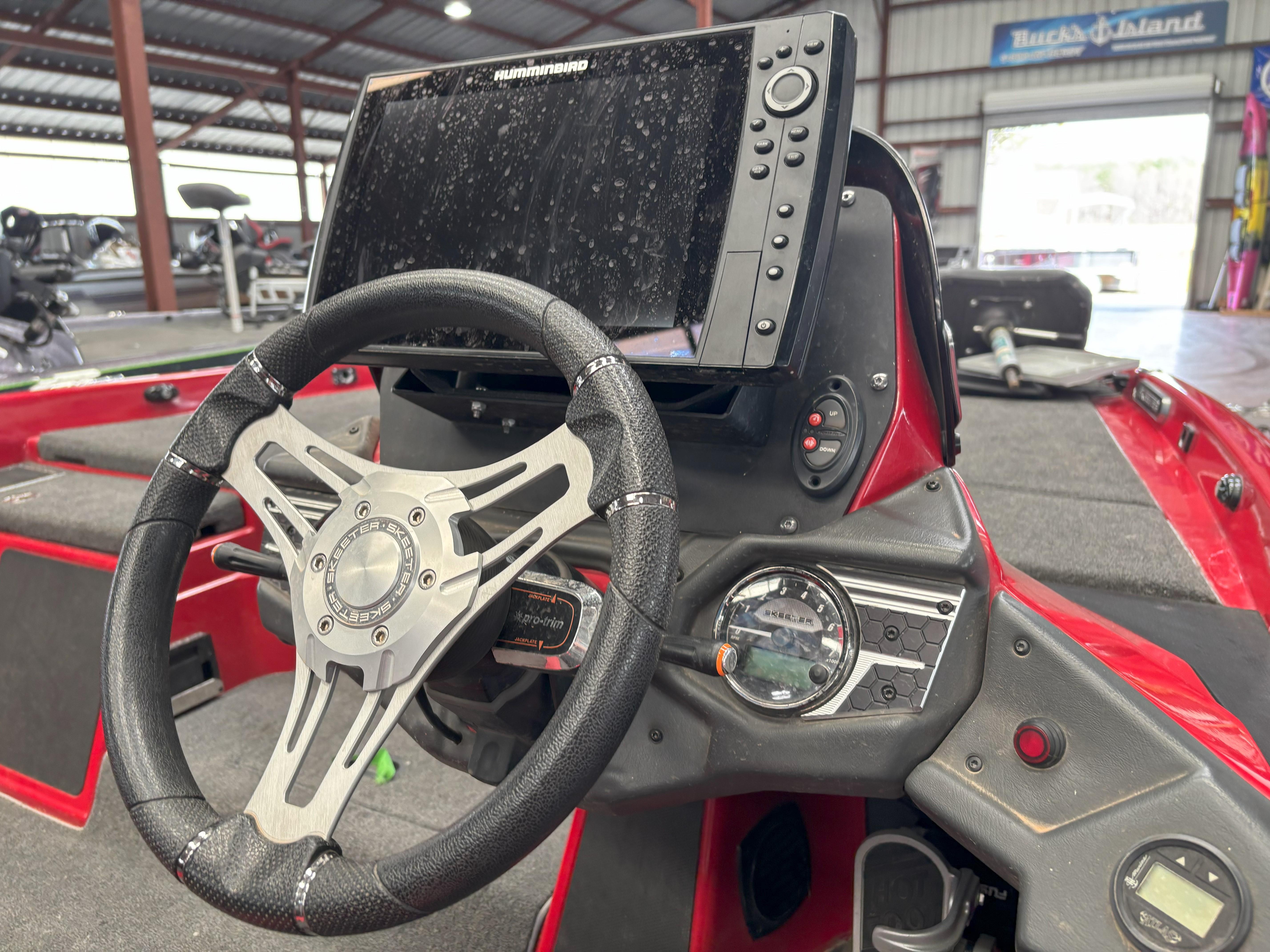 Slide: The Image of 2020 Skeeter FXR20 Apex boat dashboard with steering wheel and Humminbird display. - 9