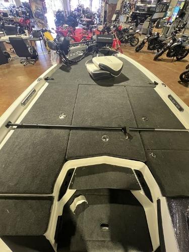 Slide: The Image of 2023 Skeeter FXR21 Limited boat interior in showroom with motorcycles in background. - 7