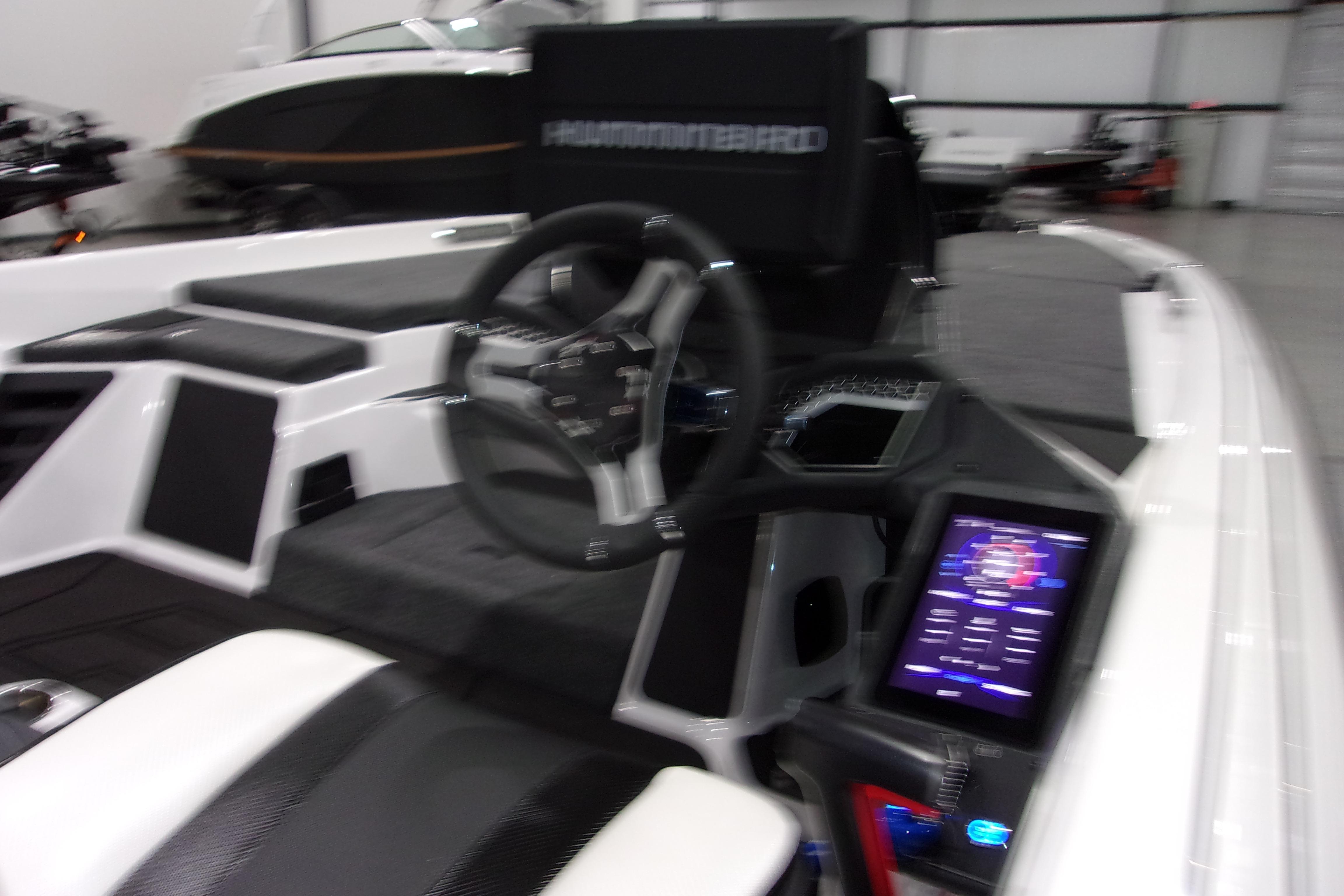 Slide: The Image of 2025 Skeeter FXR21 Limited boat interior with steering wheel and digital display. - 13