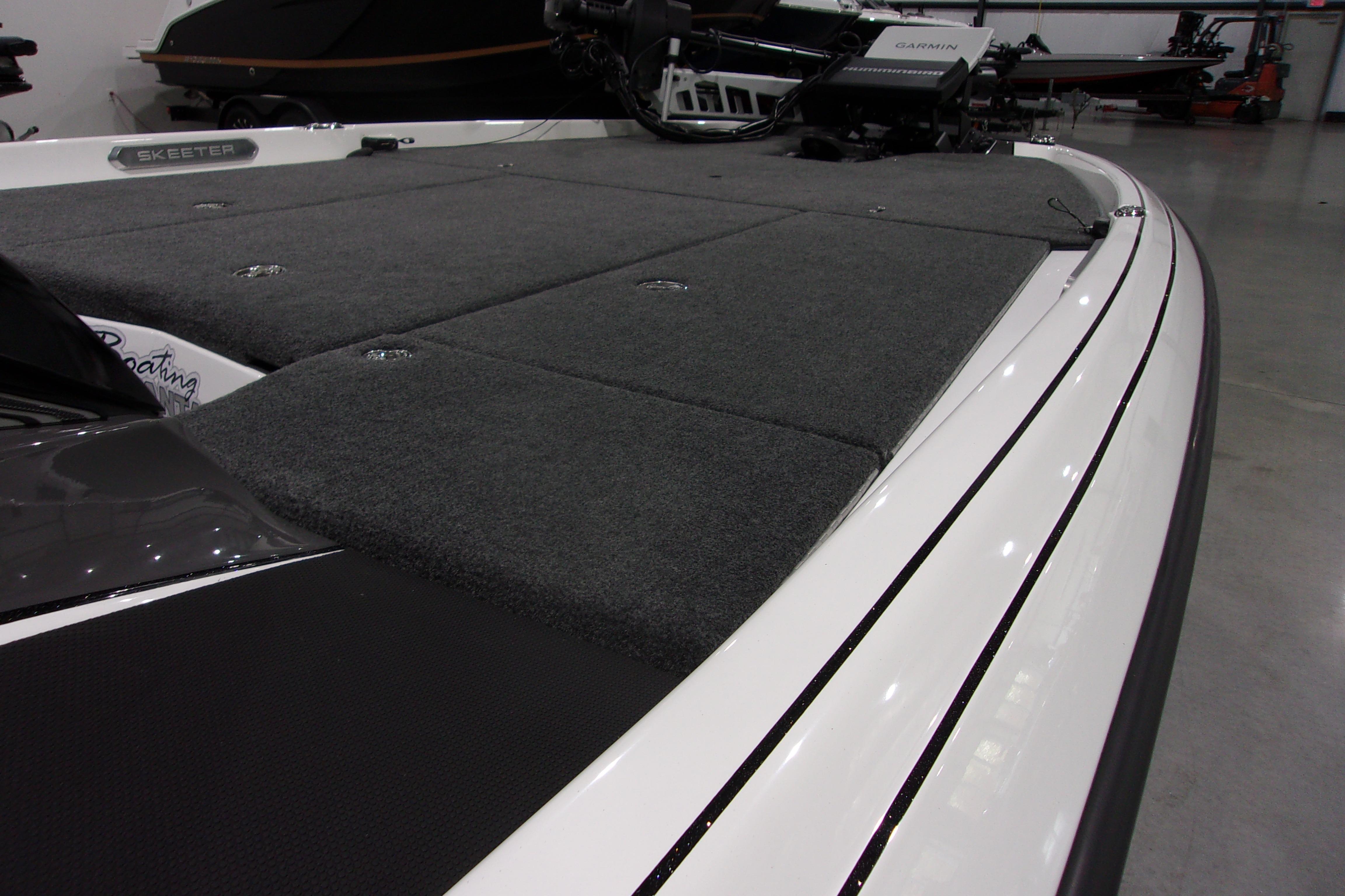 Slide: The Image of 2025 Skeeter FXR21 Limited boat deck with sleek design and carpeted surface. - 15