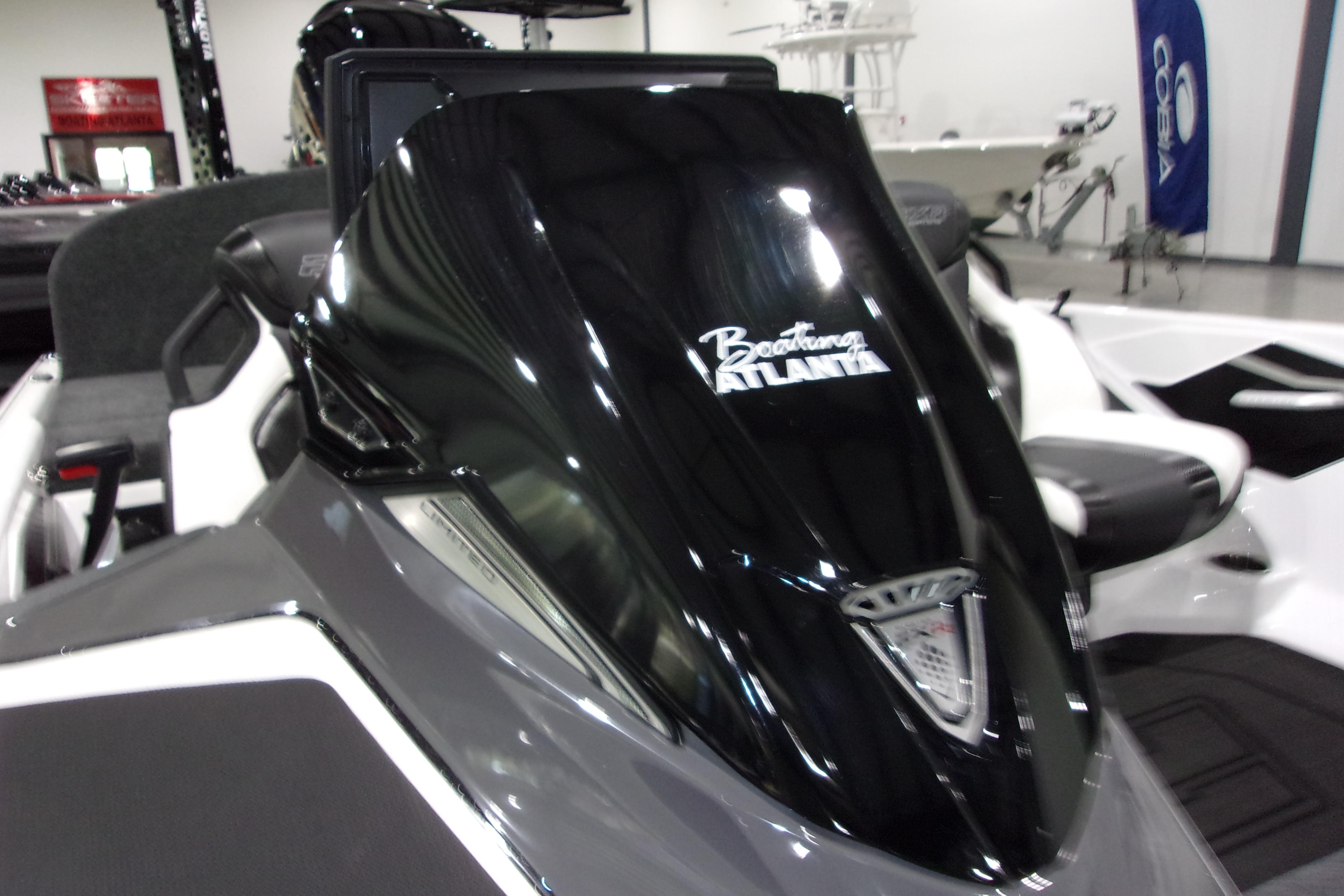 Slide: The Image of 2025 Skeeter FXR21 Limited boat with sleek black and gray design in showroom. - 16