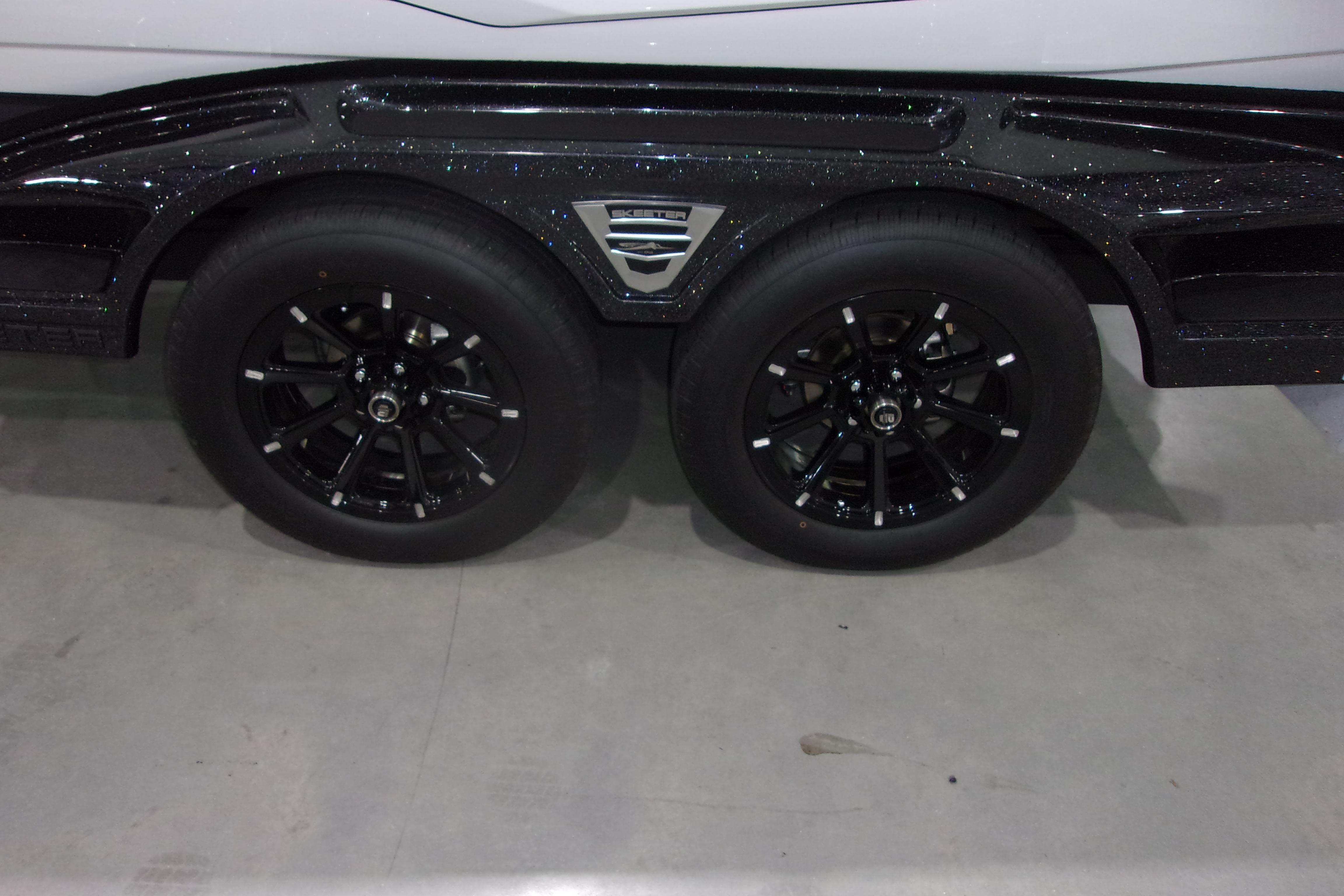 Slide: The Image of 2025 Skeeter FXR21 Limited trailer with black alloy wheels and sleek design. - 20