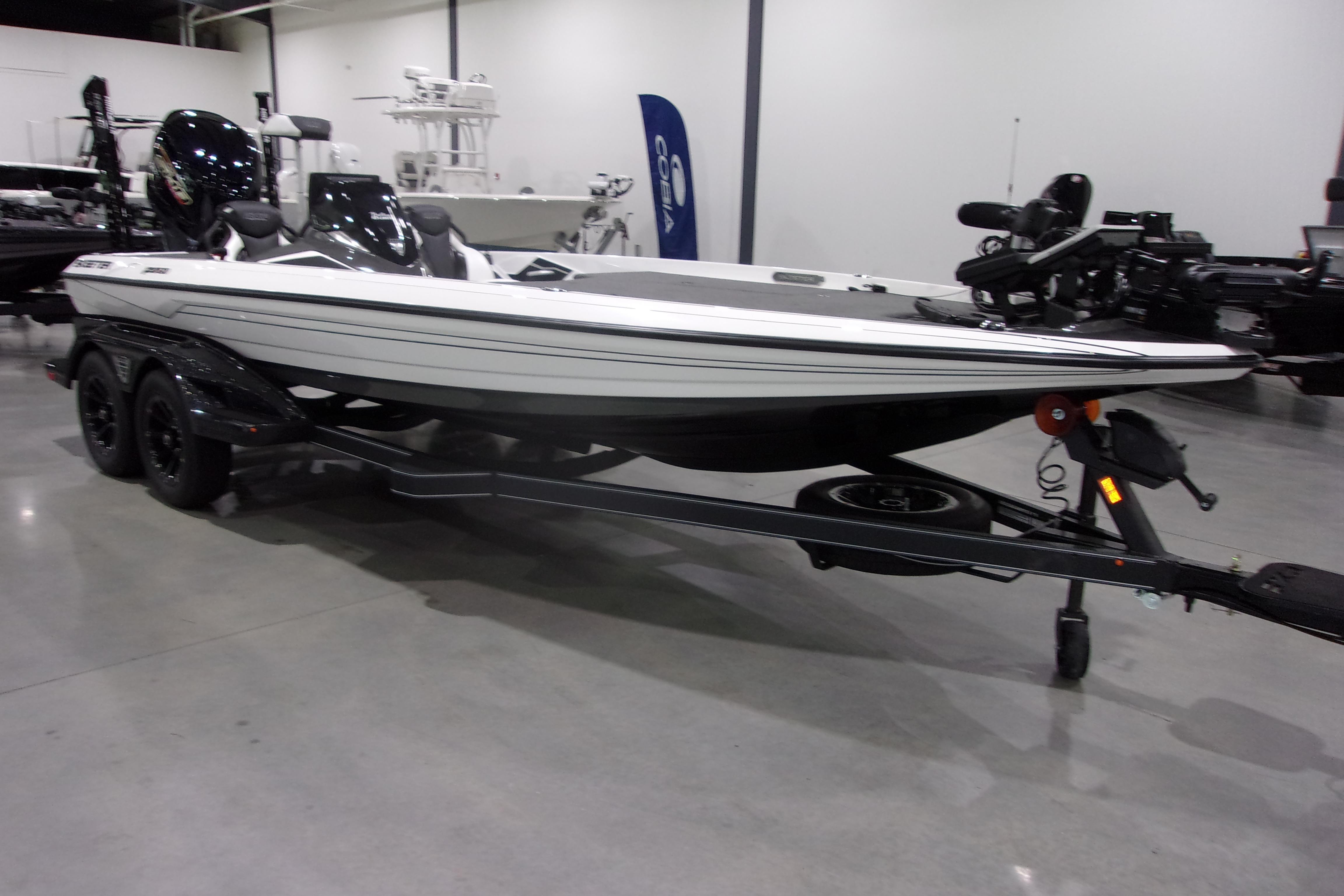 Slide: The Image of 2025 Skeeter FXR21 Limited boat on trailer in showroom setting. - 3