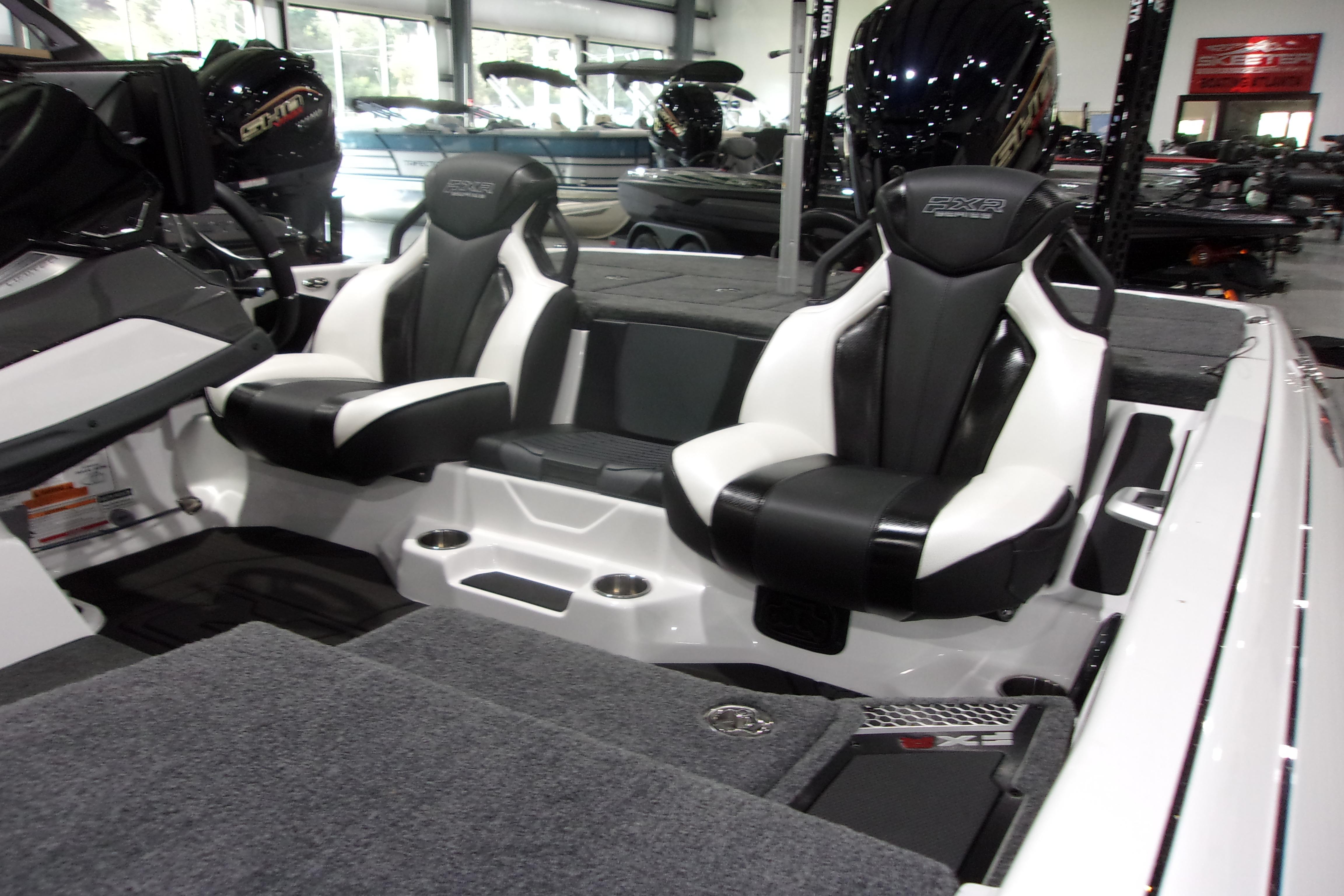 Slide: The Image of 2025 Skeeter FXR21 Limited boat interior with sleek black and white seating. - 6