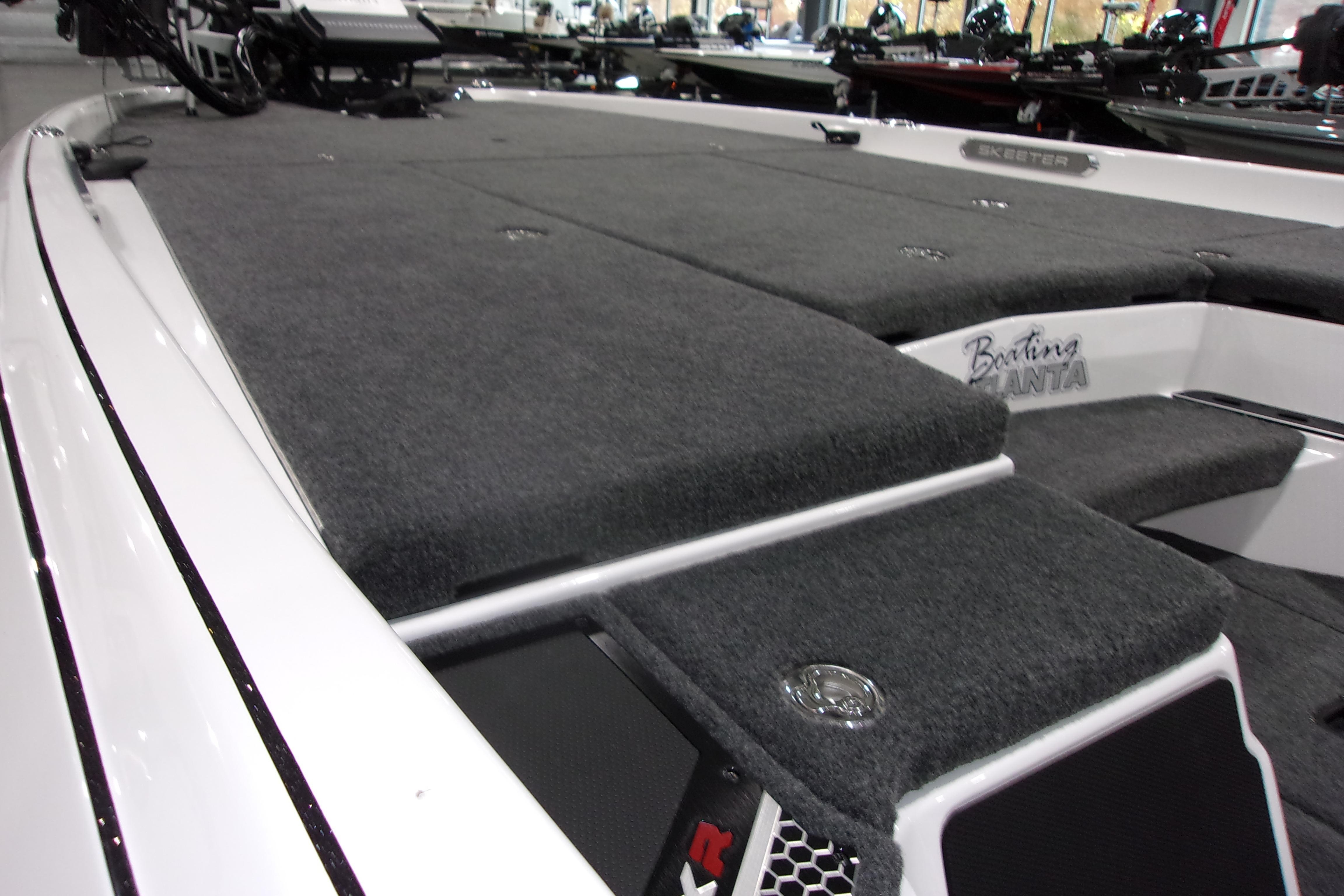Slide: The Image of 2025 Skeeter FXR21 Limited boat with spacious carpeted deck and sleek design. - 7