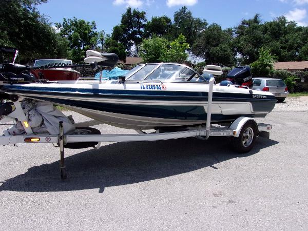 Slide: The Image of 2007 Skeeter SL 180 boat on a trailer in a parking lot. - 0