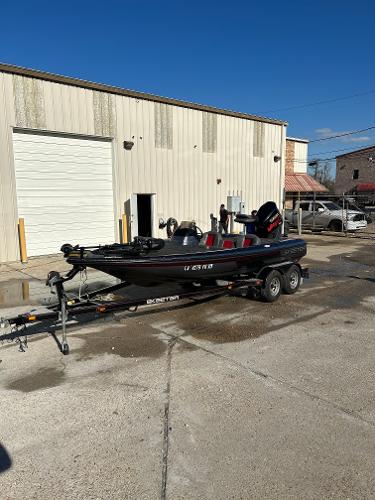 Slide: The Image of 2003 Skeeter SX 200 boat on a trailer outside a warehouse. - 1