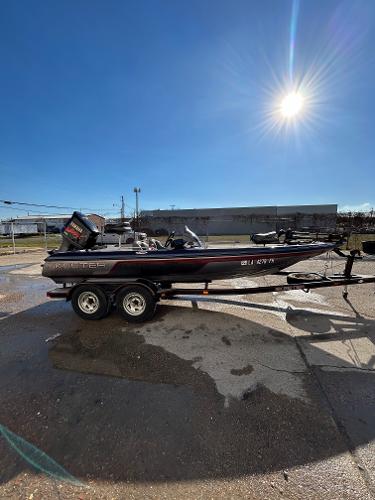 Slide: The Image of 2003 Skeeter SX 200 boat on a trailer under a bright sun. - 10