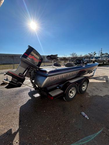 Slide: The Image of 2003 Skeeter SX 200 boat with Yamaha outboard motor on trailer. - 13
