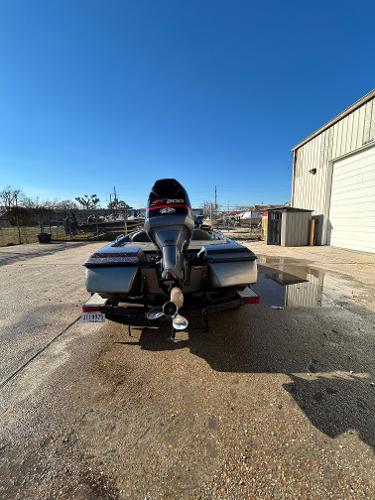 Slide: The Image of 2003 Skeeter SX 200 boat parked outside a garage on a sunny day. - 14