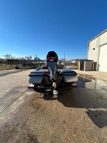 Slide: The Image of 2003 Skeeter SX 200 boat parked outside a warehouse on a sunny day. - 15