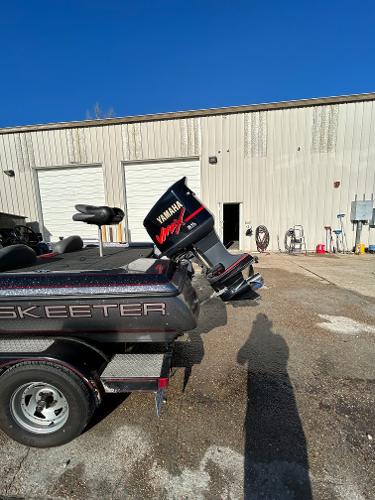 Slide: The Image of 2003 Skeeter SX 200 boat with Yamaha VMAX outboard motor in a parking lot. - 16