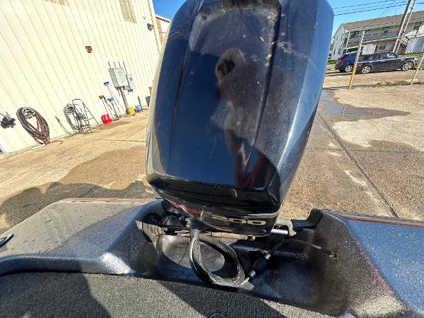 Slide: The Image of 2003 Skeeter SX 200 boat engine in a parking lot. - 18