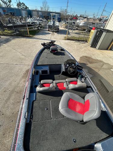 Slide: The Image of 2003 Skeeter SX 200 fishing boat with red and gray seats in a marina. - 19
