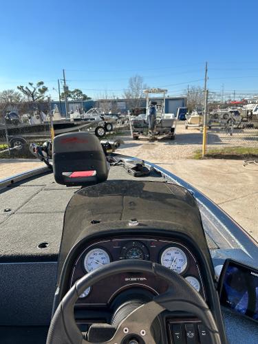Slide: The Image of 2003 Skeeter SX 200 boat dashboard and controls in a marina. - 25