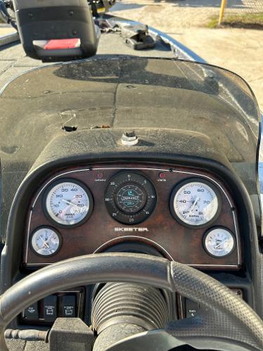 Slide: The Image of 2003 Skeeter SX 200 boat dashboard with gauges and steering wheel. - 26