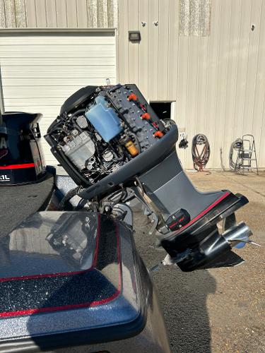 Slide: The Image of 2003 Skeeter SX 200 boat with an exposed outboard motor in a garage. - 32