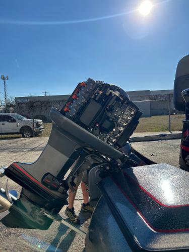 Slide: The Image of 2003 Skeeter SX 200 boat engine under maintenance in a sunny outdoor setting. - 33