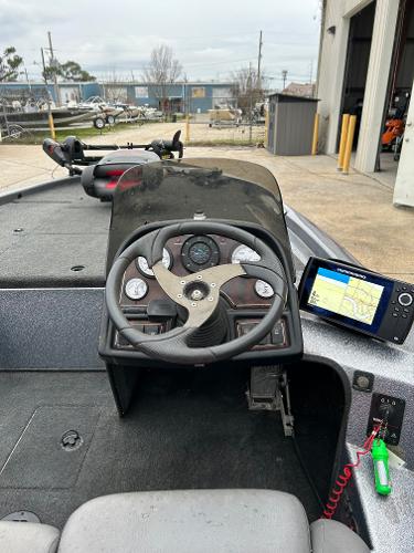 Slide: The Image of 2003 Skeeter SX 200 boat dashboard with steering wheel and navigation system. - 36