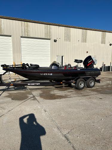 Slide: The Image of 2003 Skeeter SX 200 boat on a trailer in front of a warehouse. - 4
