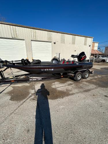 Slide: The Image of 2003 Skeeter SX 200 boat on a trailer in front of a garage. - 5