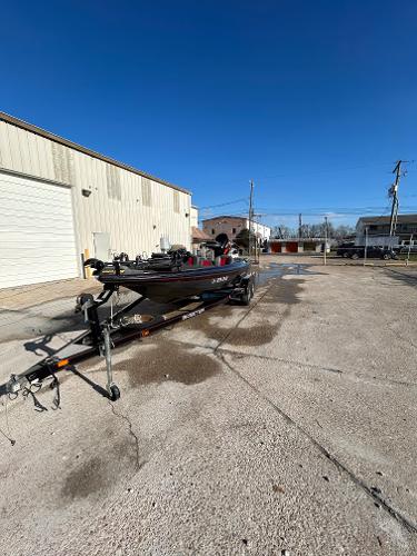 Slide: The Image of 2003 Skeeter SX 200 boat on a trailer in a parking lot. - 6