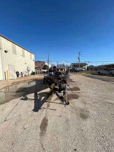 Slide: The Image of 2003 Skeeter SX 200 boat on a trailer in an outdoor lot. - 7