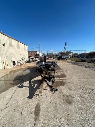 Slide: The Image of 2003 Skeeter SX 200 boat parked outdoors on a sunny day. - 8