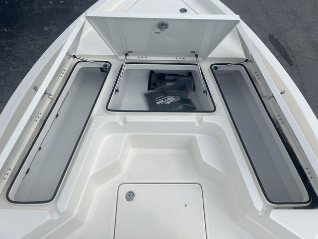 Slide: The Image of 2023 Skeeter SX210 boat storage compartments open. - 12