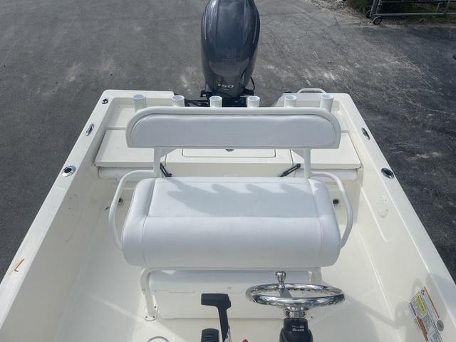Slide: The Image of 2023 Skeeter SX210 boat interior with white seating and steering wheel. - 17