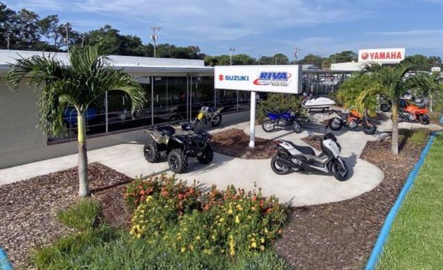 Slide: The Image of Outdoor display of Suzuki and Yamaha motorcycles and ATVs at a dealership. - 22