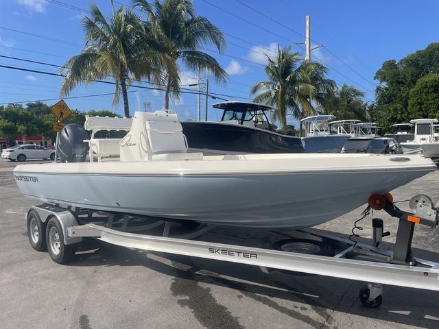 Slide: The Image of 2023 Skeeter SX210 boat on trailer with palm trees in background. - 4