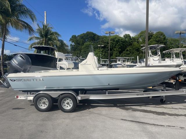 Slide: The Image of 2023 Skeeter SX210 boat on a trailer in a marina. - 5
