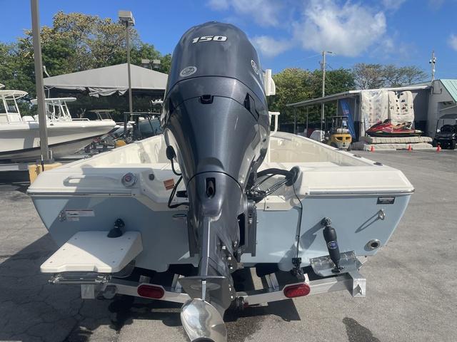 Slide: The Image of 2023 Skeeter SX210 boat with 150 HP engine, rear view at marina. - 7