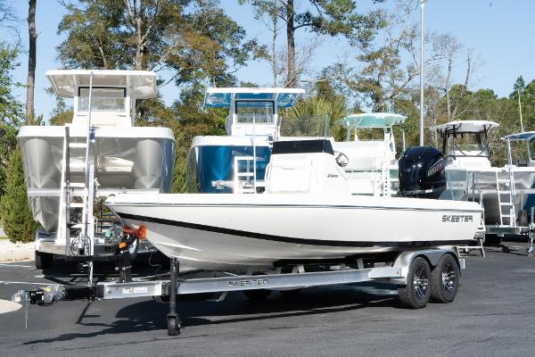 Slide: The Image of 2024 Skeeter SX 210 boat on a trailer in a marina. - 1