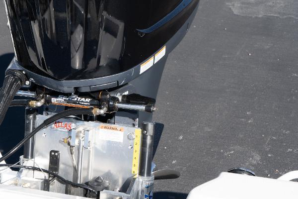 Slide: The Image of Close-up of the 2024 Skeeter SX 210 boat's outboard motor and hydraulic steering system. - 14