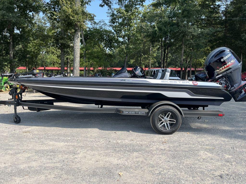 Slide: The Image of 2024 Skeeter ZX150 boat on trailer in outdoor setting. - 0