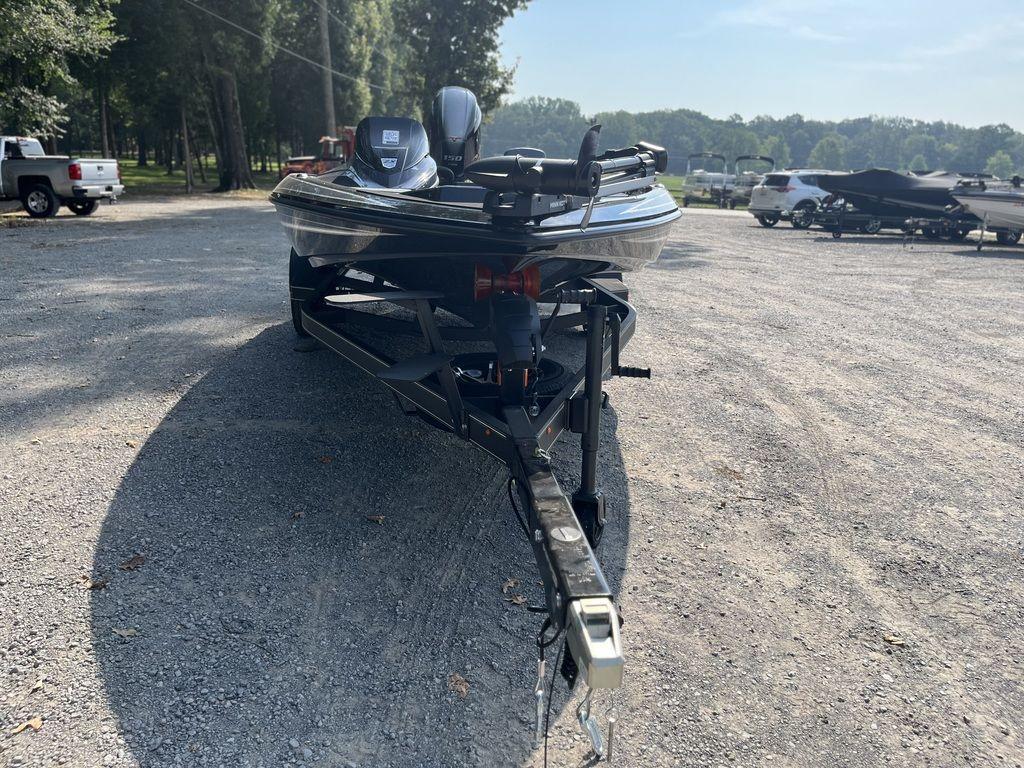Slide: The Image of 2024 Skeeter ZX150 boat on a trailer in a gravel parking lot. - 1