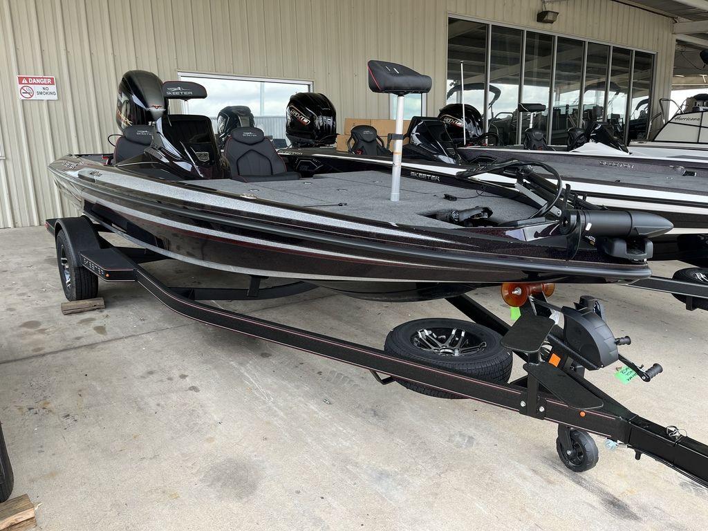 Slide: The Image of 2024 Skeeter ZX150 bass boat on a trailer, parked in a showroom. - 1